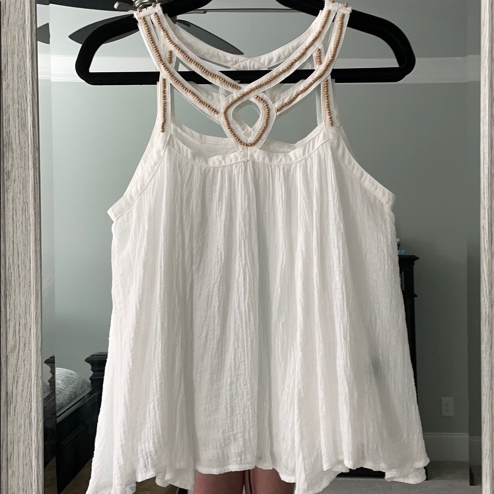 White sleeveless top with beaded detail
